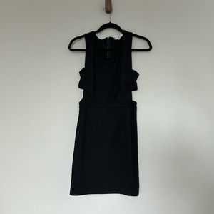 Black mini dress. Side cutouts, back zip.